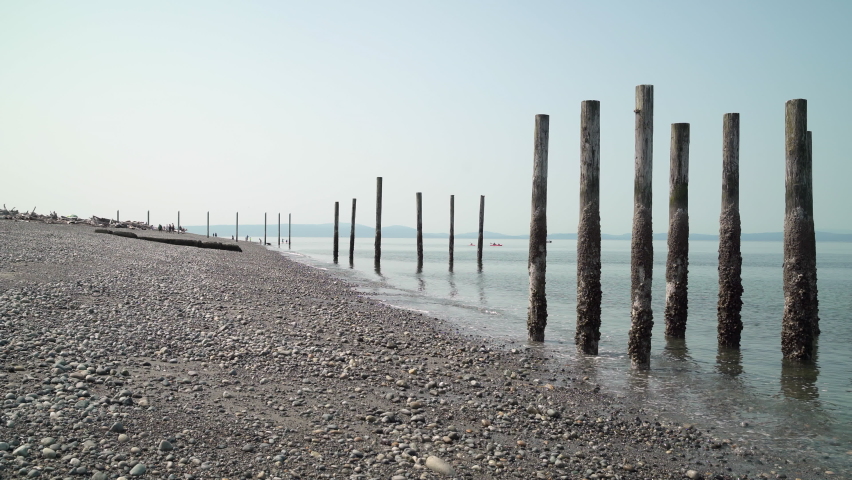 Point Roberts Pebble Beach and Pilings 4K UHD. The pebble beach in Point Roberts, Washington State, looking out across Georgia Strait. USA. 4K, UHD.

