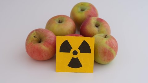 Apples with a radiation warning sign on them. Close up.