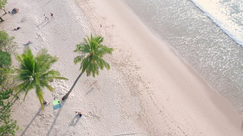Aerial drone crowd of people at tropical Beach with sunset in Phuket, Thailand, Beautiful Phuket beach is famous tourist destination at Andaman sea. Top view happy people play on the beach