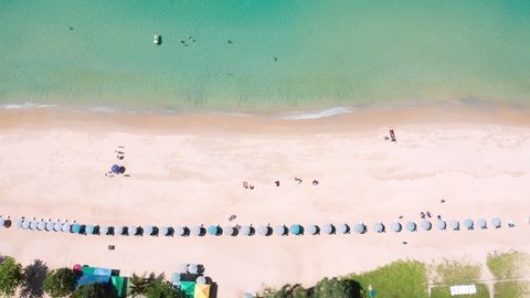 Aerial drone top view crowd of people at tropical Beach with sunset in Phuket, Thailand, Beautiful Phuket beach is famous tourist destination at Andaman sea. Top view happy people play on the beach