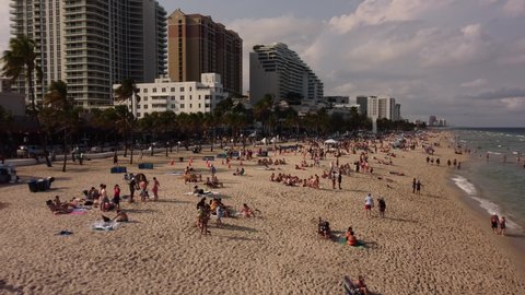 Fort Lauderdale, FL, USA - March 20, 2022: Spring Break crowds Fort Lauderdale Beach FL. 4k aerial drone video