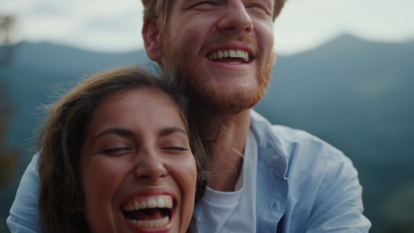 Portrait of cheerful family having fun outdoor. Closeup happy couple faces laughing outside. Joyful man and woman spending summer holiday honeymoon together in mountains. Joy happiness concept. | Shutterstock HD Video #1088583901