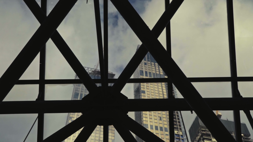 View of skyscrapers under construction through the technical ceiling of the exhibition pavilion | Shutterstock HD Video #1088589389