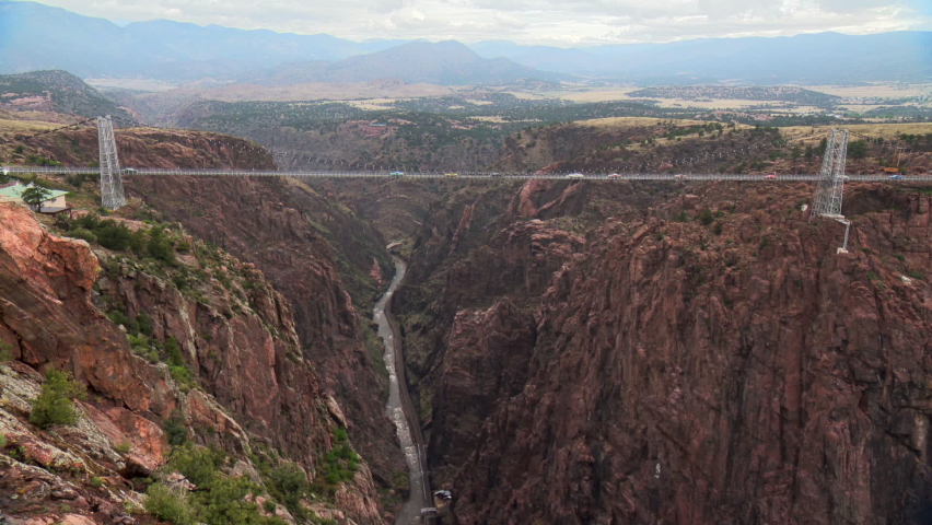 Royal Gorge Bridge in Colorado with cars crossing above the Arkansas River. America’s highest suspension bridge.