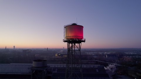 Aerial view of Water tower in Bochum city, Germany. Industrial heritage of Ruhr region, dawn drone orbit