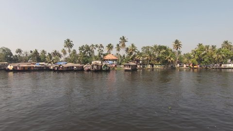 Boat cruise on the Alleppey backwaters, local lifestyle along river bank; India