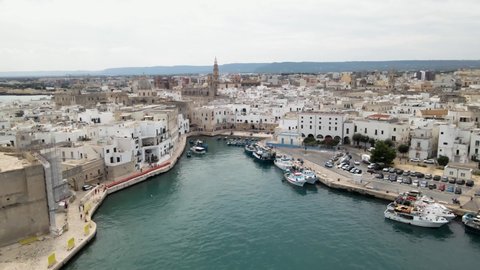 Aerial drone tilt up revealing beautiful Monopoli from a lighthouse. Monopoli, Italy