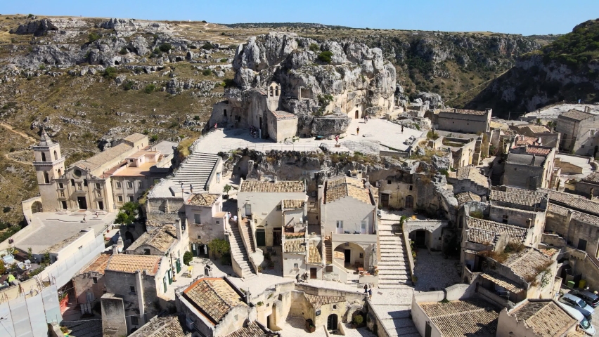 Aerial drone shot headed toward a huge rock in Matera, Italy. The oldest ancient city in Europe.