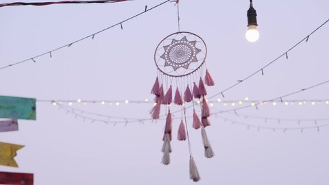 Decorative pink hanging dreamcatchering with the wind outdoors
