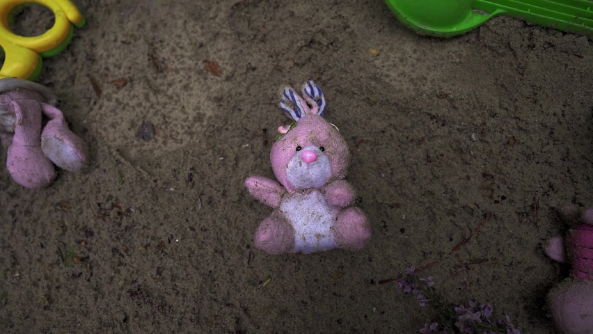 toys on the ground. Ukrainian child war. homeless children