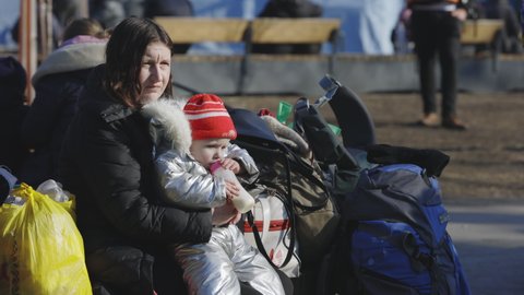 Lviv, Ukraine - March 15, 2022: Mother and her child. Refugees from Ukraine at the railway station. War at Ukraine concept. Editorial Stock Footage