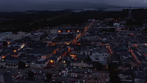Aerial panoramic shot of evening town. Colour illuminated streets and town development. Killarney, Ireland