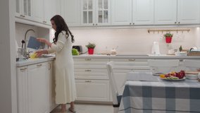 Woman cooking dinner in the kitchen. High quality 4k footage