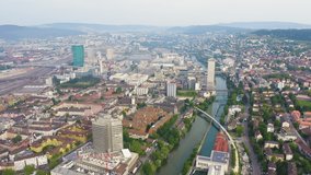 Inscription on video. Zurich, Switzerland. Panorama of the city from the air. Gewerbeschule area, Limmat river. Glitch effect text, Aerial View, Departure of the camera