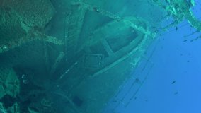 Scuba divers swims on the Shipwreck Swedish ferry MS Zenobia. Wreck diving. Mediterranean sea, Cyprus. Maritime disasters. Underwater 4K video filming Shot Of Sunken Ship. World tragedies under water