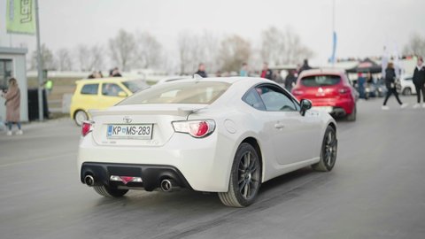 KRSKO, SLOVENIA – MARCH 2022: Street legal cars open meet. Tracking white Toyota Supra arriving on performance cars exhibition 4K