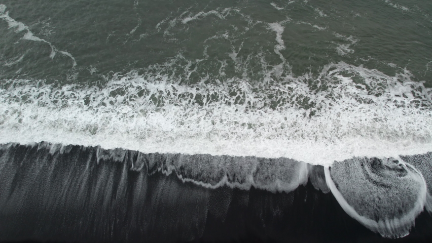Wide Overhead Slow Motion Drone Shot From White Tide And Surf On Black Sand Beach, East Iceland | Shutterstock HD Video #1088602589