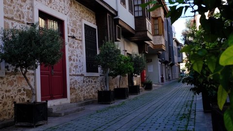 Antalya, Turkey December 25, 2021: Ottoman houses on pedestrian street in old town of Kaleici district, walk through the old city in Antalya. winter season
