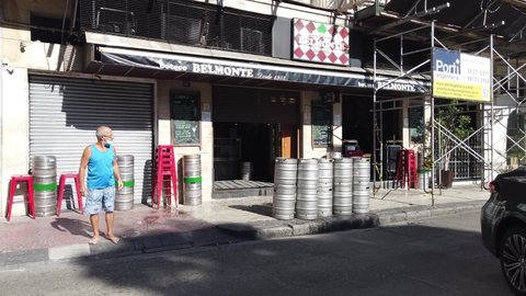 Rio de Janeiro, RJ, Brazil - March 21st 2022 - Opening time of a bar restaurant early in the morning. Beer kegs stacked, chairs stacked. Street with scaffolding, and workers open time.