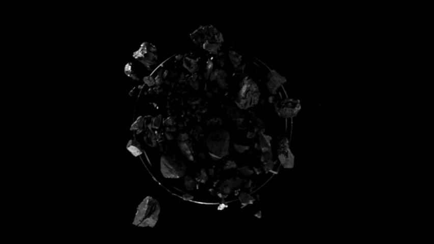 Super slow motion of rotating coal pieces on black background. Filmed on high speed cinema camera, 1000fps. Royalty-Free Stock Footage #1088612037