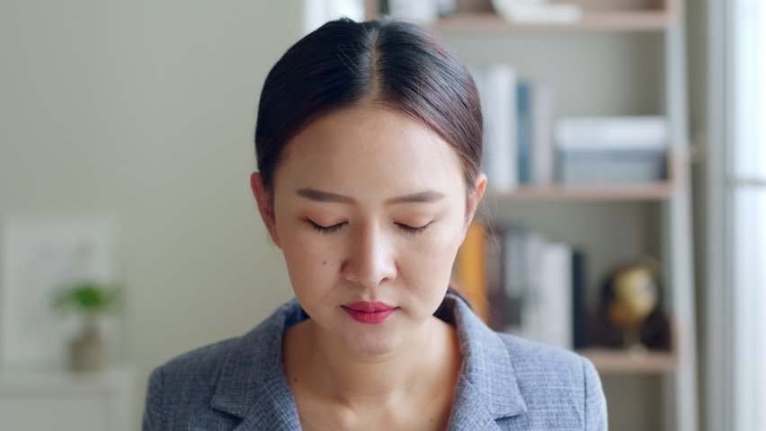 Close up of Young Asian businesswoman, call center, customer service wearing headphone and smiling. Look at camera Royalty-Free Stock Footage #1088612849