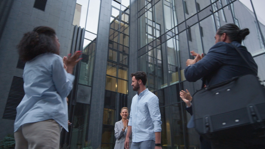 Happy team appreciate employee outside office building. Best worker recognition. Joyful colleagues corporate people clapping hands celebrating triumph. Euphoric boss leader greeting encouraging group. Royalty-Free Stock Footage #1088613439