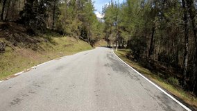 Video of driving downhill a curvy mountain asphalted forest road in valley in Cyprus.