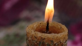 Yellow magic wax candle sprinkled with grass, a ritual candle of memory and purification of the house, a beautiful decor item - Powered by Shutterstock - Get 15% off with code: PIKWIZARD15