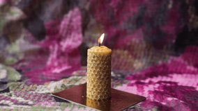 Yellow magic wax candle sprinkled with grass, a ritual candle of memory and purification of the house, a beautiful decor item - Powered by Shutterstock - Get 15% off with code: PIKWIZARD15