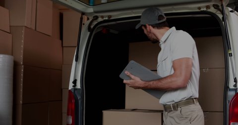 Animation of financial data and graphs over happy caucasian courier working in warehouse. business, finance and delivery services concept digitally generated video.