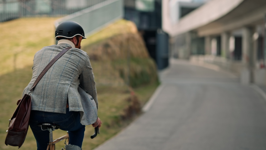Businessman going to work on bike. Eco friendly transport | Shutterstock HD Video #1088623363