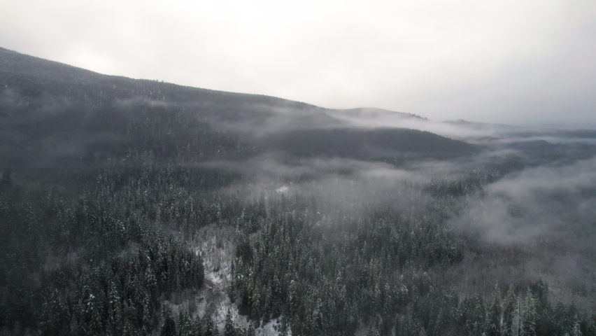 High Aerial View of Mountain Valley with Lowland Fog in Winter