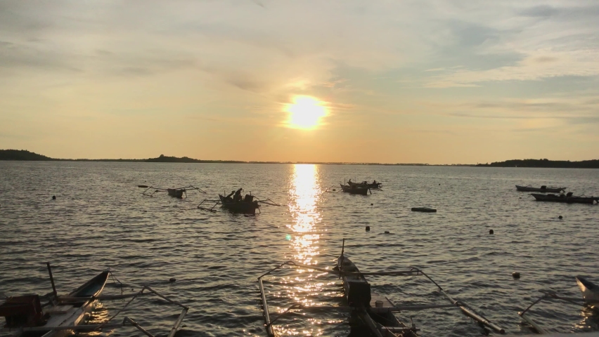 fishing boat on the sea with sunset background