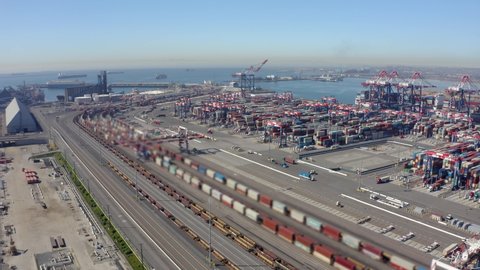 Cargo containers in busy port, aerial. Drone shot. Shipping harbor, logistics. Drone Flight Over Busy Container Yard. 4K Aerial view of Industrial port with containers ship. big cargo port. 