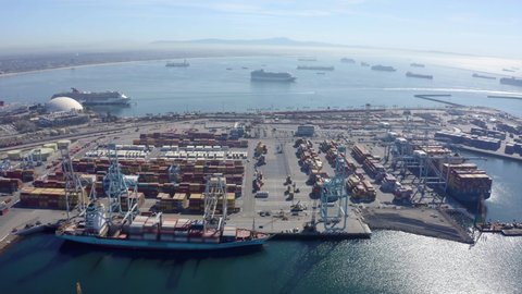 Cargo containers in busy port, aerial. Drone shot. Shipping harbor, logistics. Drone Flight Over Busy Container Yard. 4K Aerial view of Industrial port with containers ship. big cargo port. 