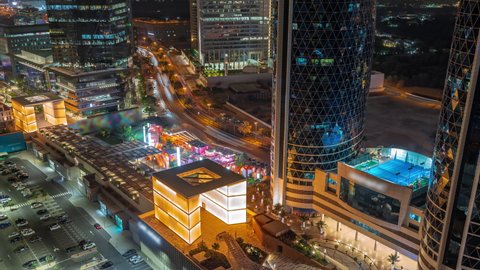 Gate Avenue promenade with illuminated arch located in Dubai international financial center aerial night timelapse. It is connecting all skyscrapers in the DIFC.