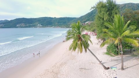 Aerial drone crowd of people at tropical Beach with sunset in Phuket, Thailand, Beautiful Phuket beach is famous tourist destination at Andaman sea. Top view happy people play on the beach