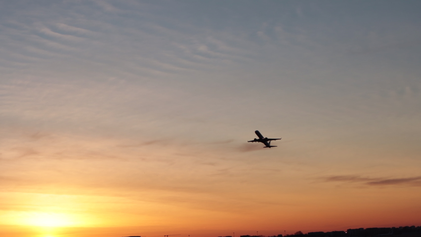 Airplane fly up over take-off in airport at sunrise Passenger flight plane silhouette, dramatic sky. Aircraft departure. International transport flying Royalty-Free Stock Footage #1088632663