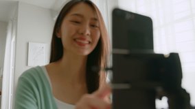 Asian young woman with her friend er created her dancing video by smartphone camera together To share video to social media application