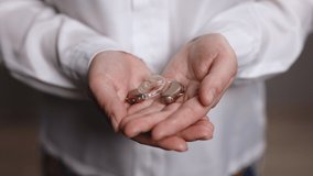 Woman holding a hearing aid. Hands Of Woman Holding A Hearing Aid. Closeup. Employee of a medical clinic shows a hearing aid. - Powered by Shutterstock - Get 15% off with code: PIKWIZARD15