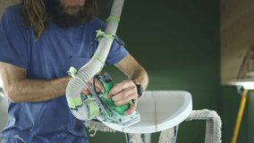 Surfboard making, shaper sands surfboard with sanding block. Concept of craftsmanship, small business in America, skilled professional in USA. Surfing industry.  - Powered by Shutterstock - Get 15% off with code: PIKWIZARD15