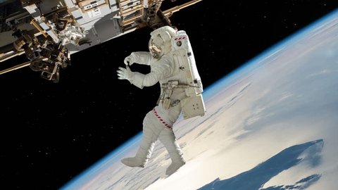 Astronaut Working On International Space Station. Elements of this image furnished by NASA