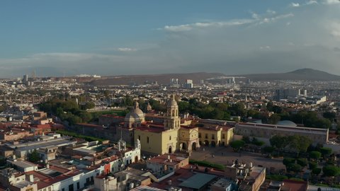 Colonial style city. Center of wine production in Mexico. Aerial drone view of old historical city with cathedral and famous cultural buildings. Sunset time over main tourist destination Queretaro