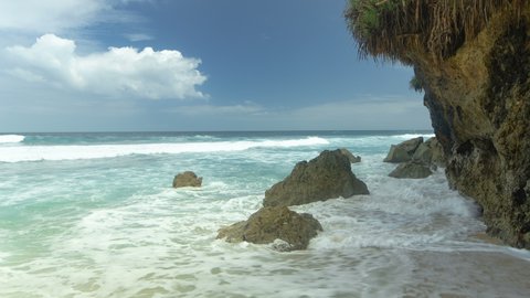 Waves and rocks on beach in Bali, Indonesia. Timelapse 4K