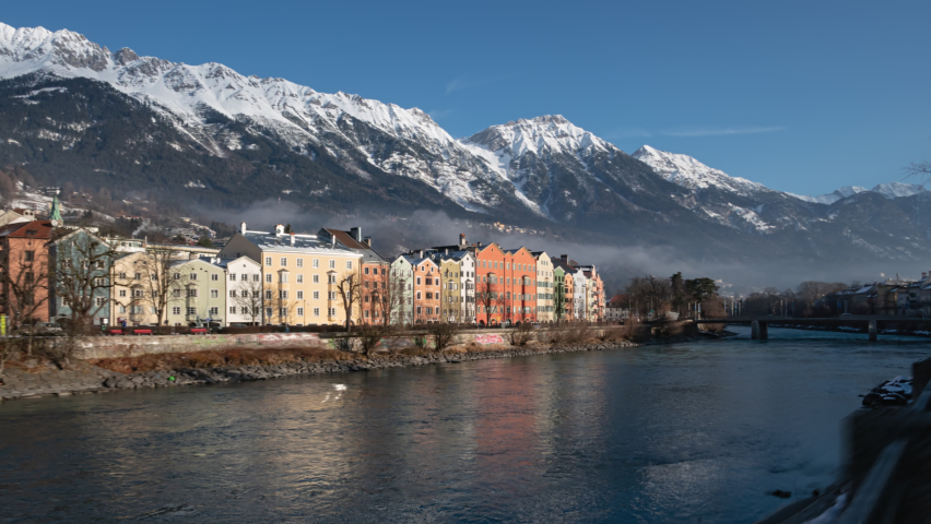 Hyper lapse Panorama of Colourful Houses on Mariahilf Street along the Inn River at clear winter morning, Innsbruck, Austria