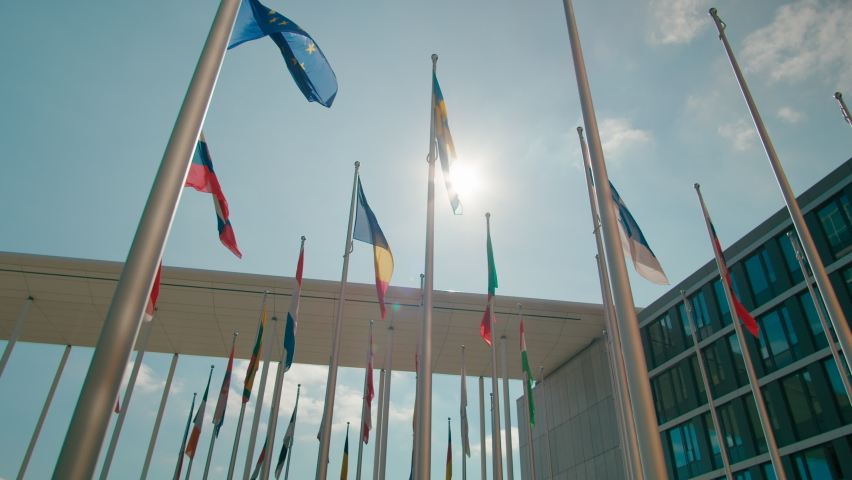 Flags of European Union Countries in Court of European Parliament administrative office in Luxembourg City, Capital of EU. Politics, Economy and Global Business background. 4K orbit wide shot Royalty-Free Stock Footage #1088648441