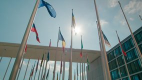 Flags of European Union Countries in Court of European Parliament administrative office in Luxembourg City, Capital of EU. Politics, Economy and Global Business background. 4K orbit wide shot - Powered by Shutterstock - Get 15% off with code: PIKWIZARD15