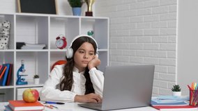 sleepy bored and lazy child study online in headphones, school