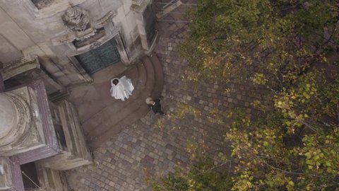 Newlyweds aerial drone view. Happy lovely bride meeting groom with bouquet in park. First meeting. Happy wedding couple family. Romantic love of man and woman. Bride in wedding dress. Bridegroom