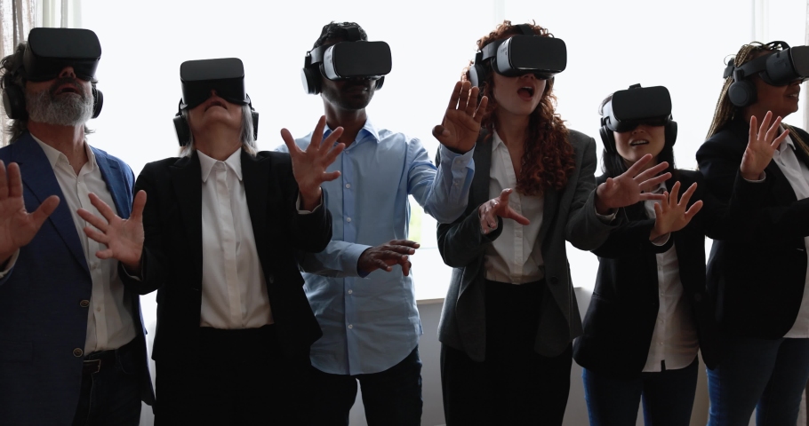 Multiracial teamwork having fun wearing virtual reality headset inside business office | Shutterstock HD Video #1088651271